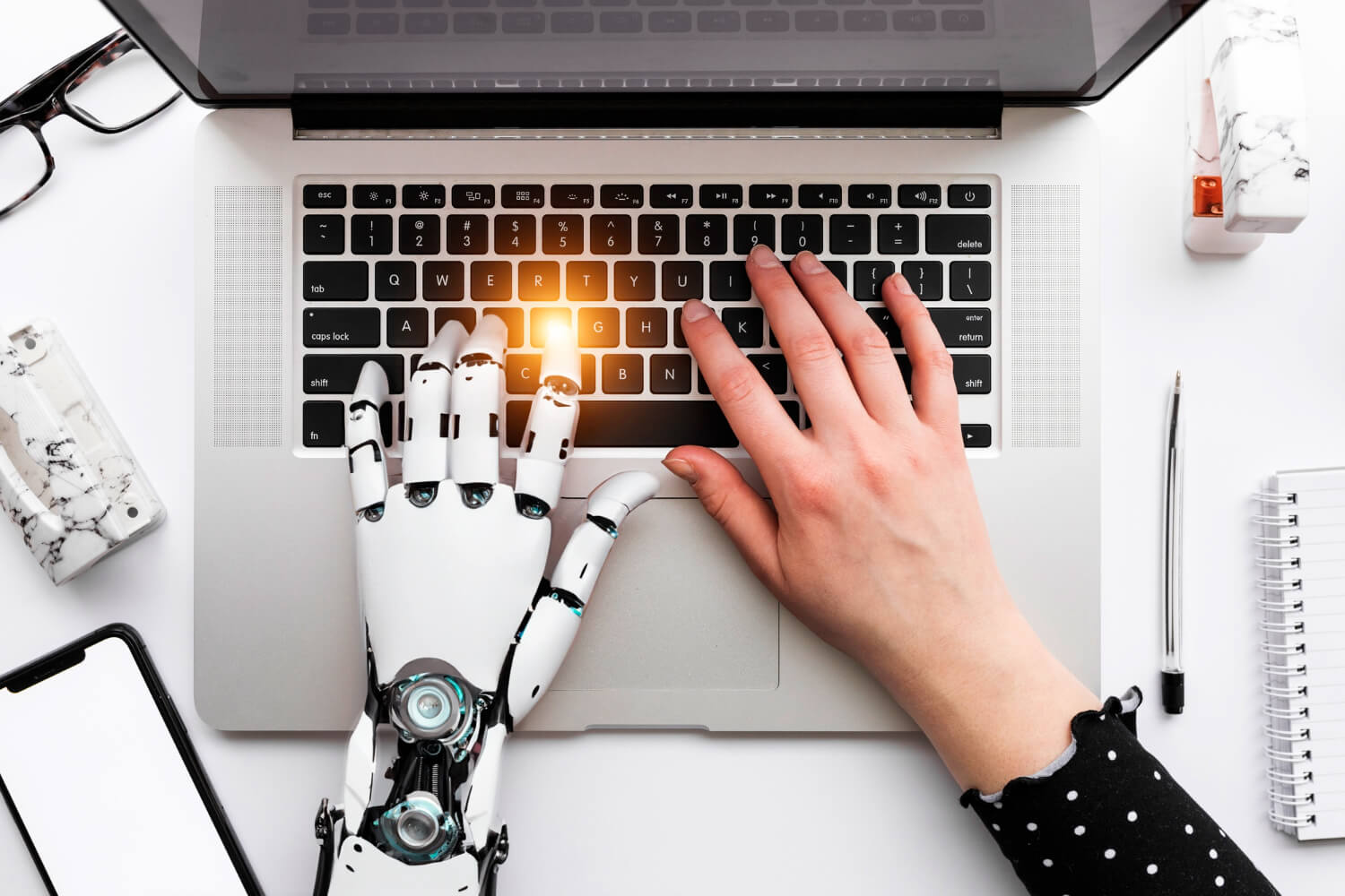 robot and human hand at the same laptop keyboard